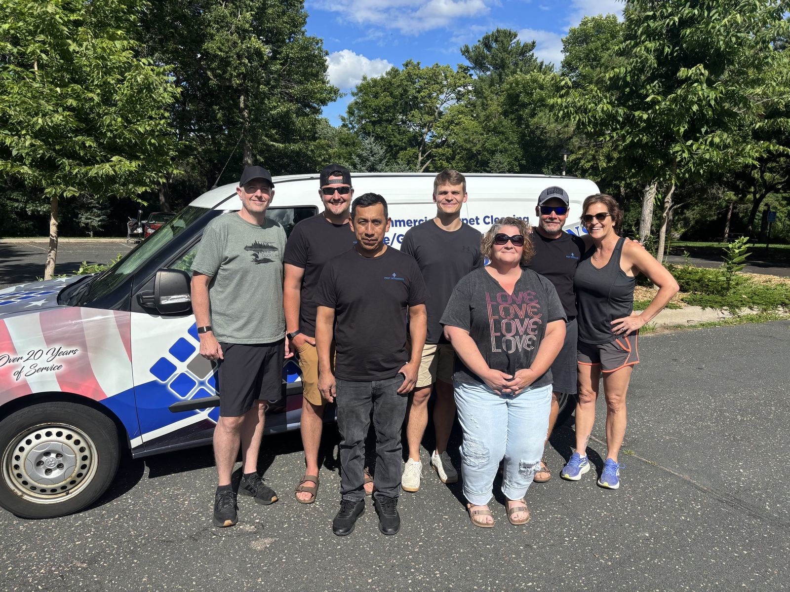 The First Impressions team with their company van